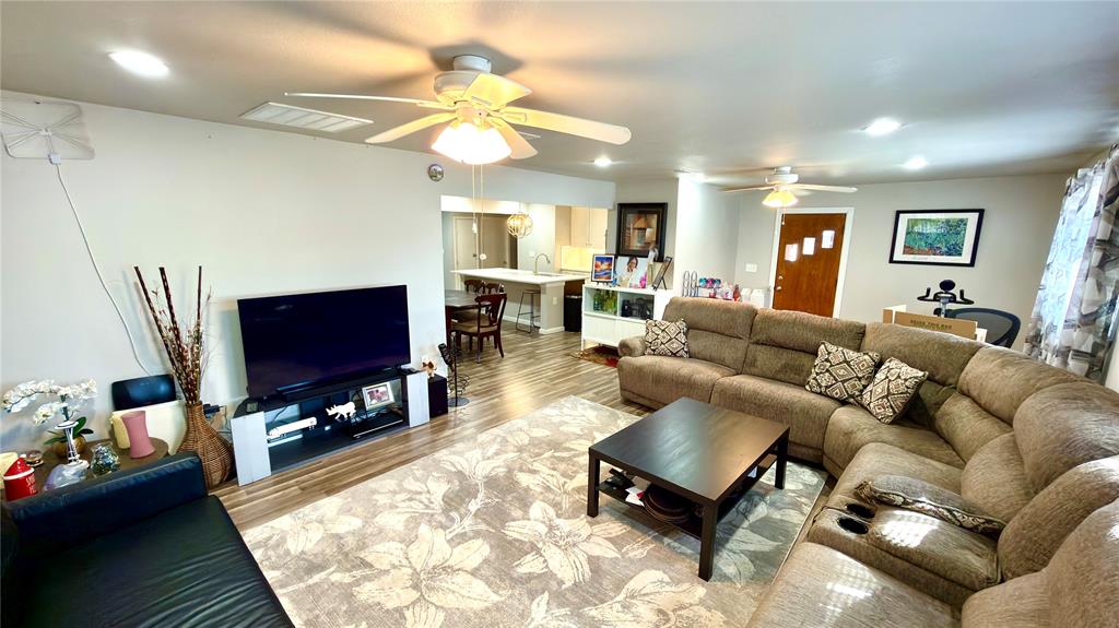 2510 Dewitt Street Irving, TX 75062 - Photo 6 of 17 a living room with furniture a flat screen tv and a fireplace