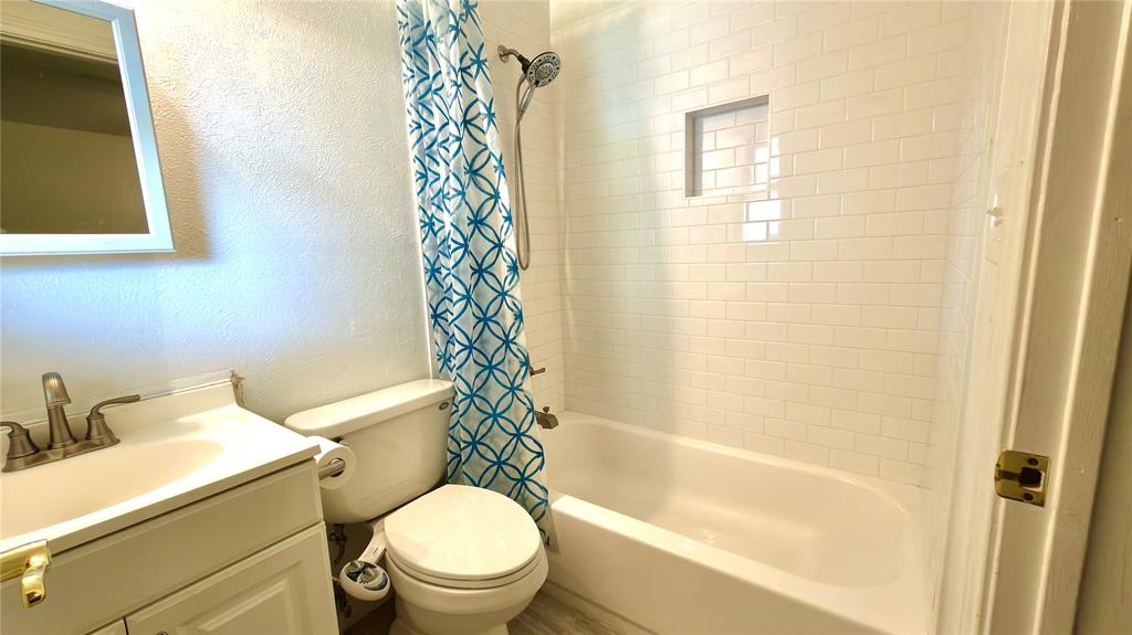 2510 Dewitt Street Irving, TX 75062 - Photo 10 of 17 a white toilet sitting next to a bath tub