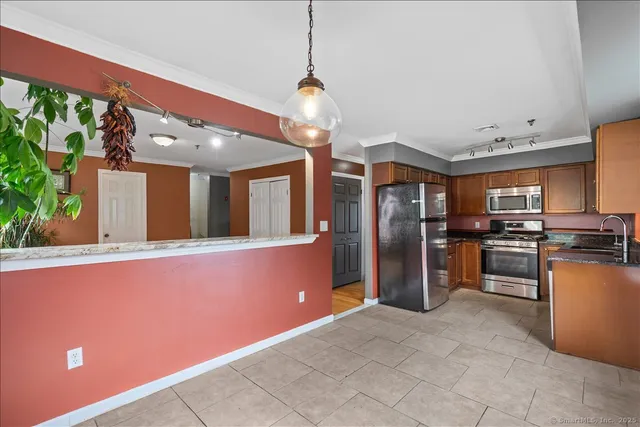a kitchen with stainless steel appliances granite countertop a refrigerator and a sink