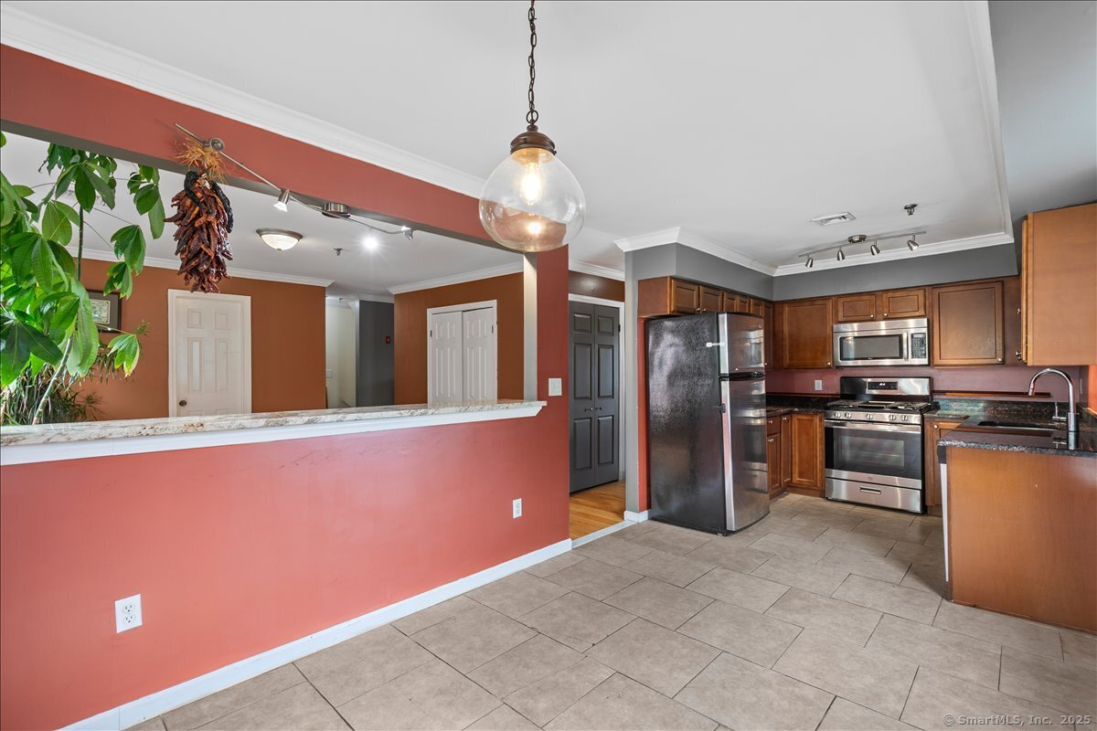 677 Quinnipiac Avenue, Unit 9 New Haven, CT 06513 - Photo 11 of 36 a kitchen with stainless steel appliances granite countertop a refrigerator and a sink
