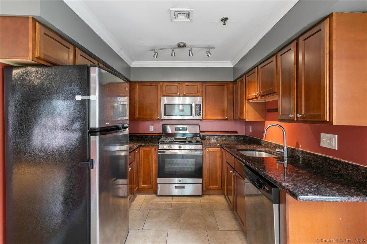 677 Quinnipiac Avenue, Unit 9 New Haven, CT 06513 - Photo 12 of 36 a kitchen with stainless steel appliances granite countertop a sink stove and refrigerator