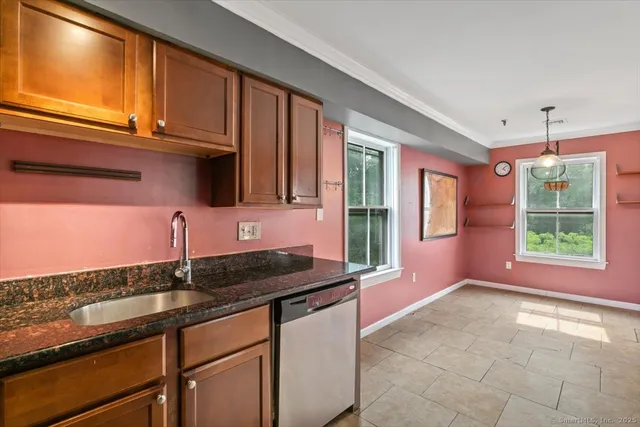 a kitchen with granite countertop a sink and a stove