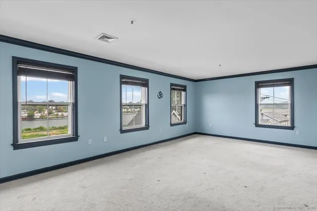 an empty room with windows and closet