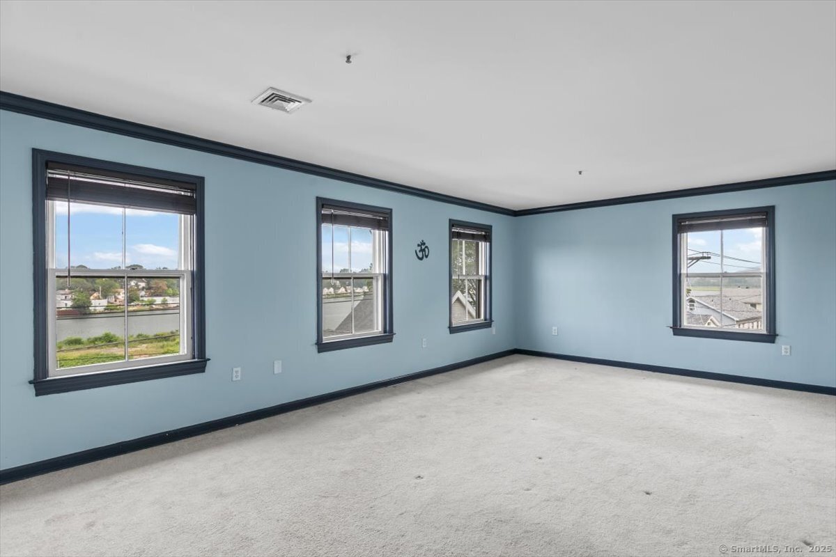 677 Quinnipiac Avenue, Unit 9 New Haven, CT 06513 - Photo 21 of 36 an empty room with windows and closet