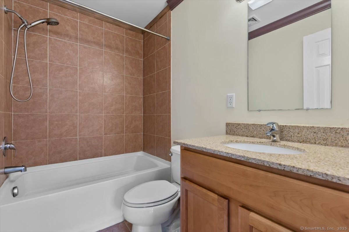 677 Quinnipiac Avenue, Unit 9 New Haven, CT 06513 - Photo 25 of 36 a bathroom with a granite countertop sink toilet and shower