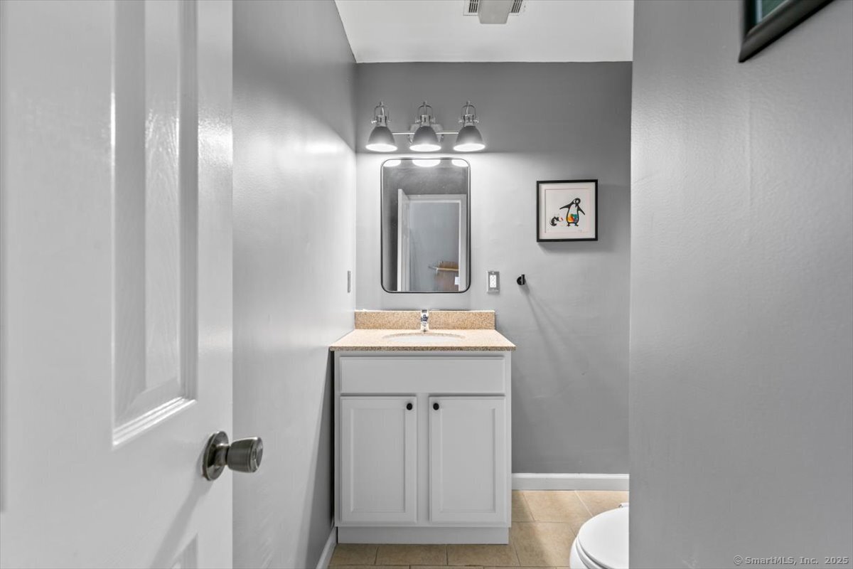 677 Quinnipiac Avenue, Unit 9 New Haven, CT 06513 - Photo 28 of 36 a bathroom with a sink and a mirror