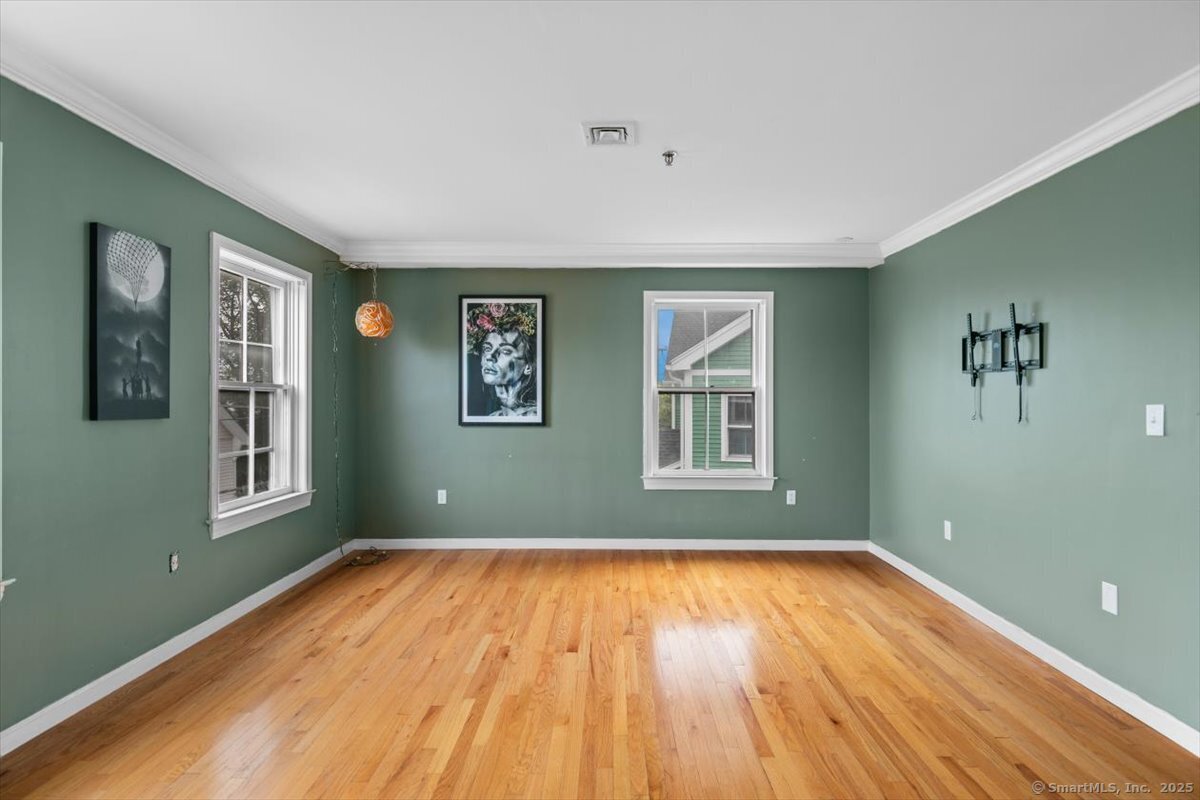 677 Quinnipiac Avenue, Unit 9 New Haven, CT 06513 - Photo 5 of 36 a view of empty room with wooden floor and fan