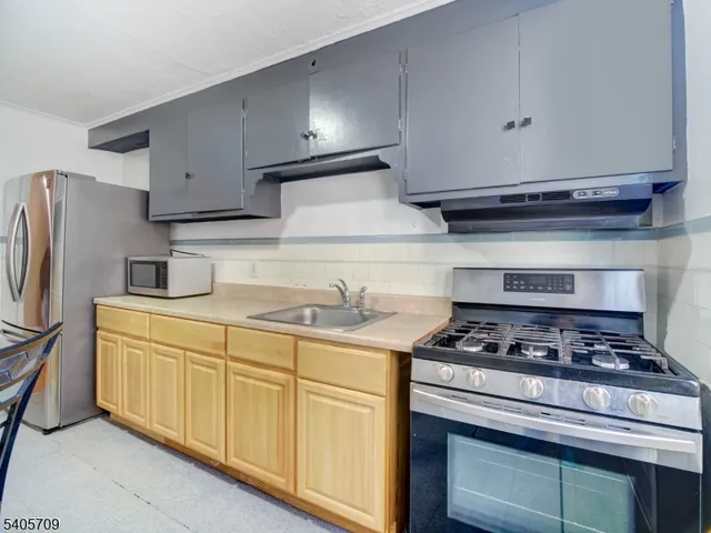 a kitchen with stainless steel appliances granite countertop a stove and a refrigerator