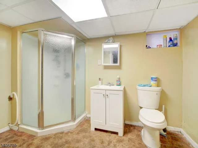 a white toilet sitting next to a bathroom sink