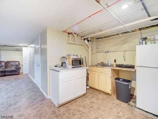 a kitchen with sink cabinets and refrigerator