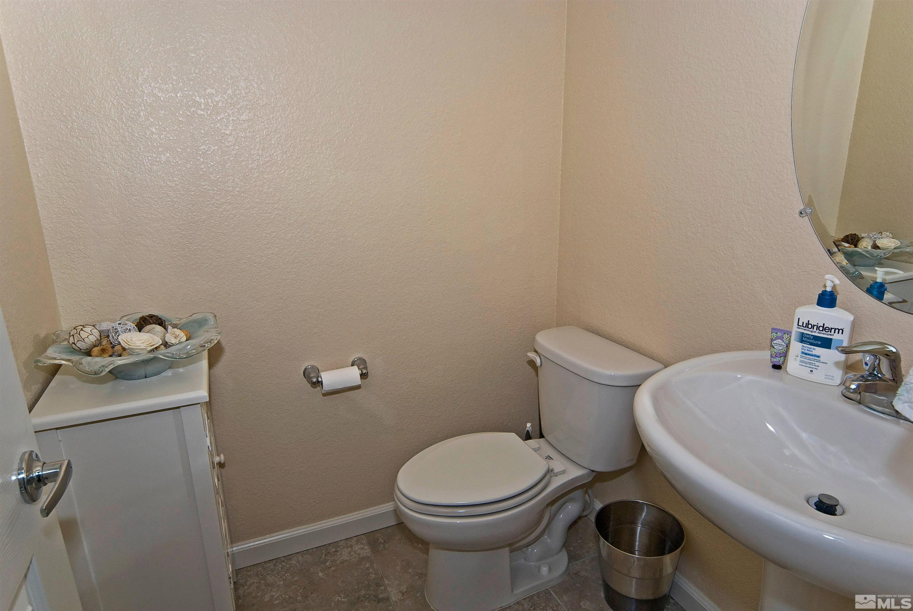 3006 Sterling Ridge Circle Sparks, NV 89431 - Photo 13 of 29 a white toilet sitting next to a bathroom sink