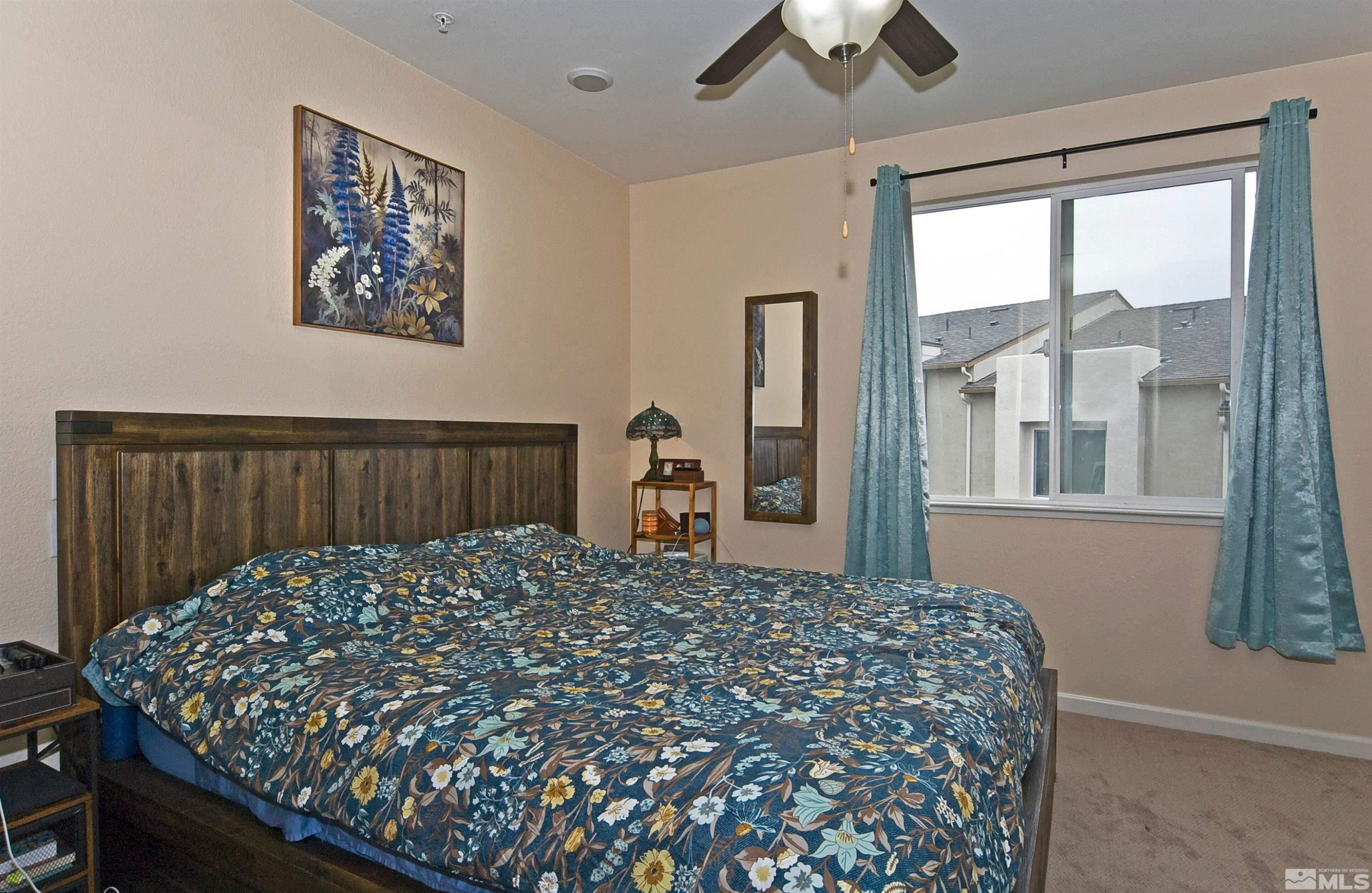 3006 Sterling Ridge Circle Sparks, NV 89431 - Photo 14 of 29 a large bed sitting in a bedroom next to a window