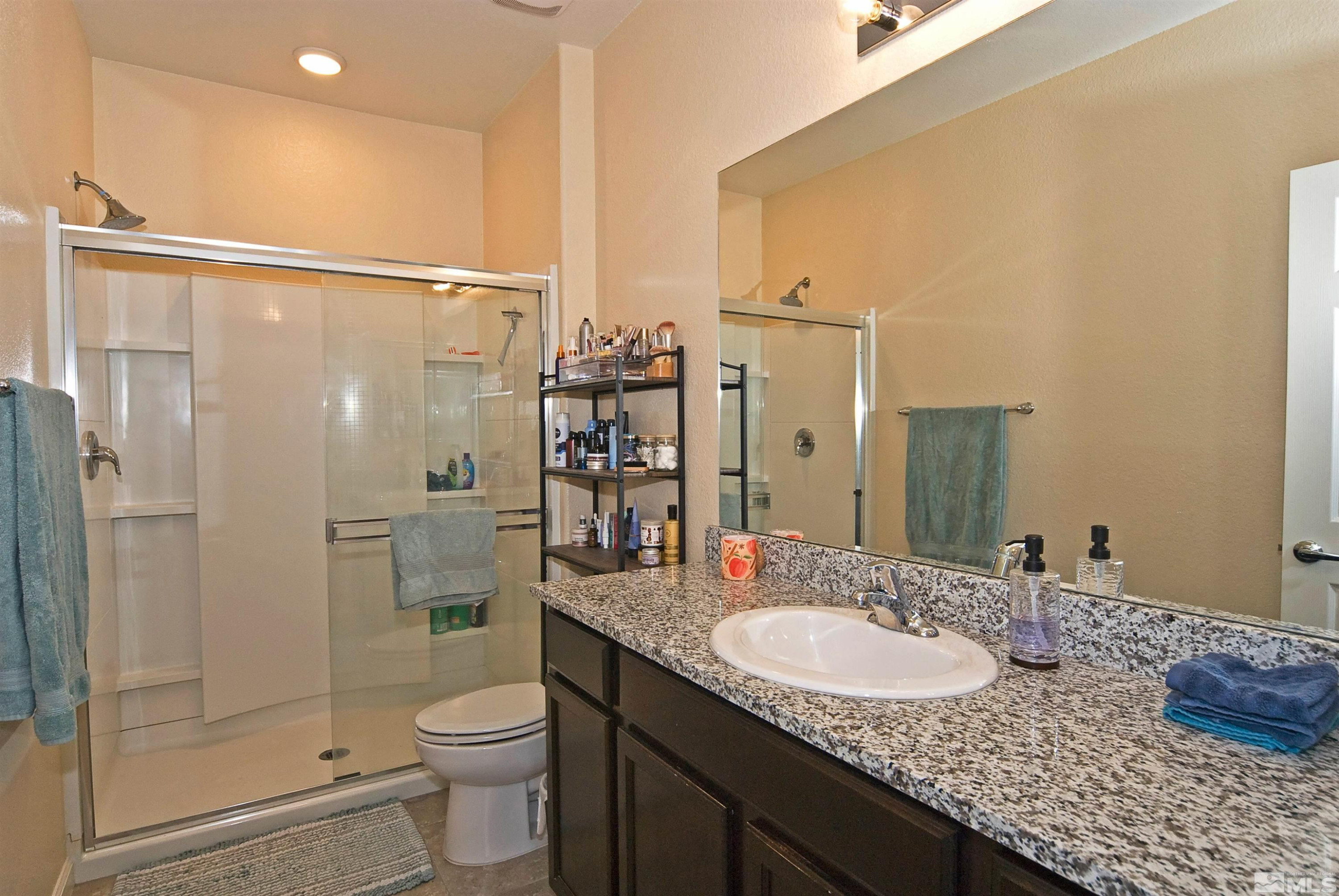 3006 Sterling Ridge Circle Sparks, NV 89431 - Photo 16 of 29 a bathroom with a granite countertop sink toilet and shower