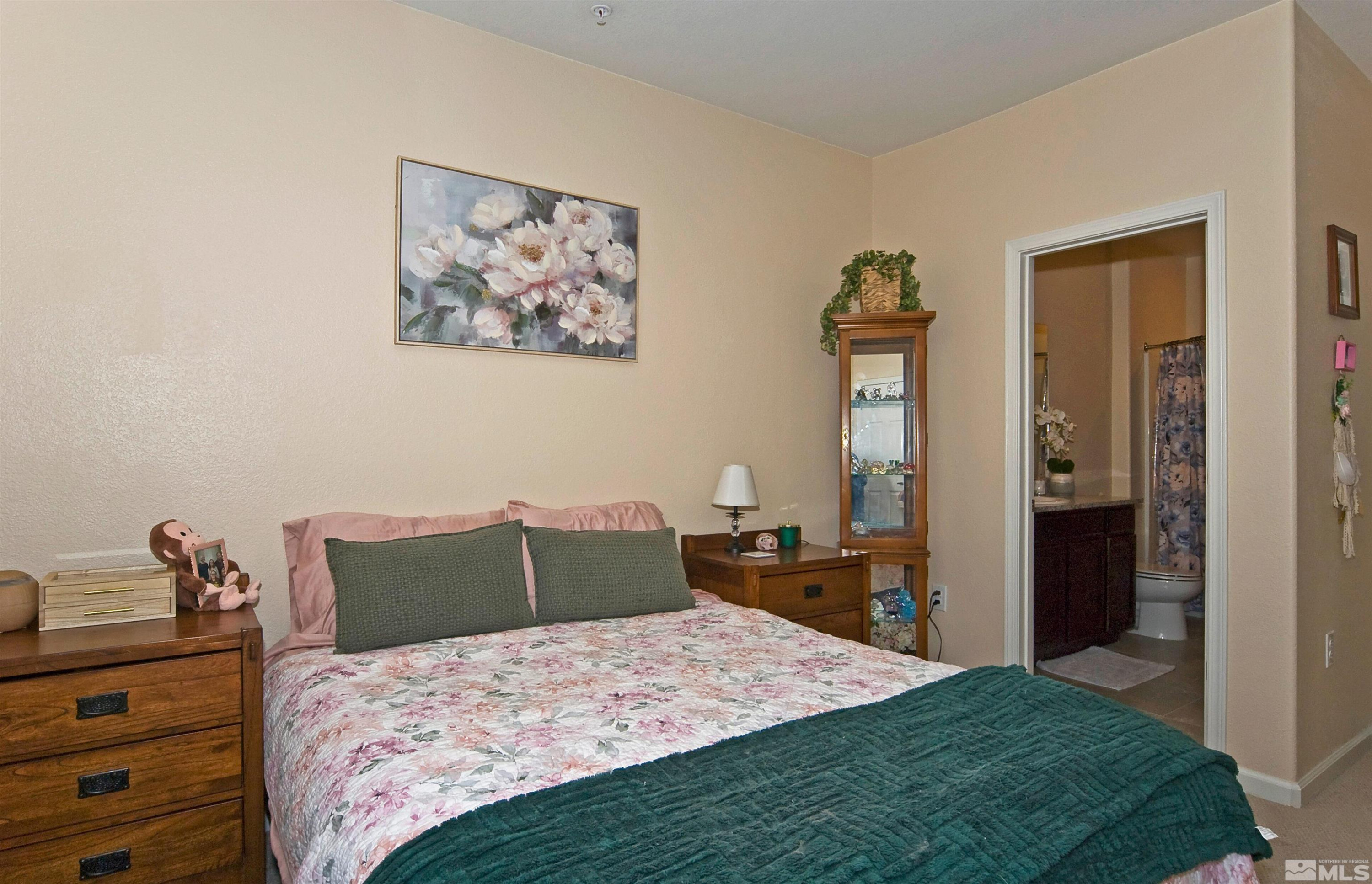 3006 Sterling Ridge Circle Sparks, NV 89431 - Photo 19 of 29 a bedroom with a bed and wooden floor