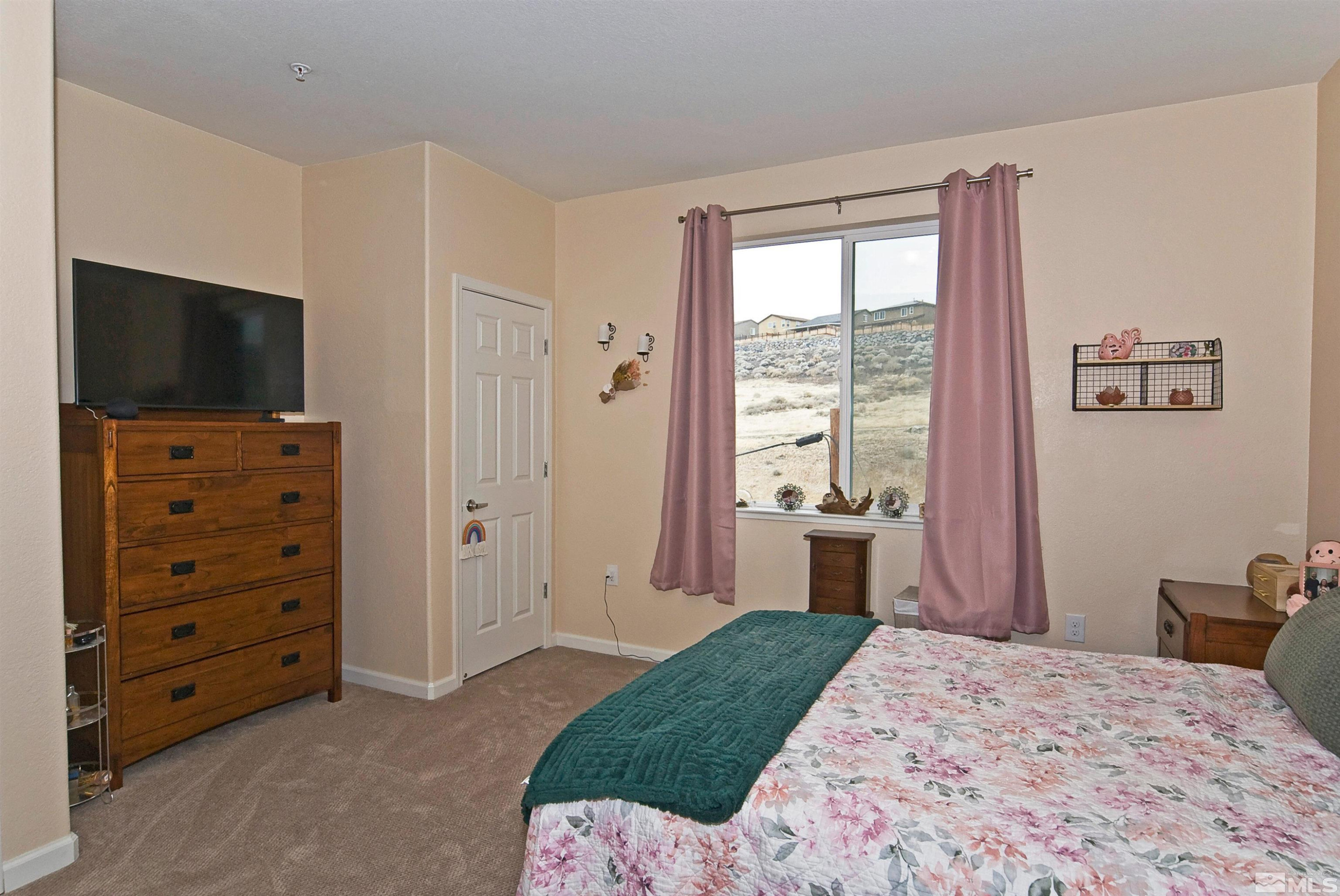 3006 Sterling Ridge Circle Sparks, NV 89431 - Photo 21 of 29 a bedroom with a bed and a television