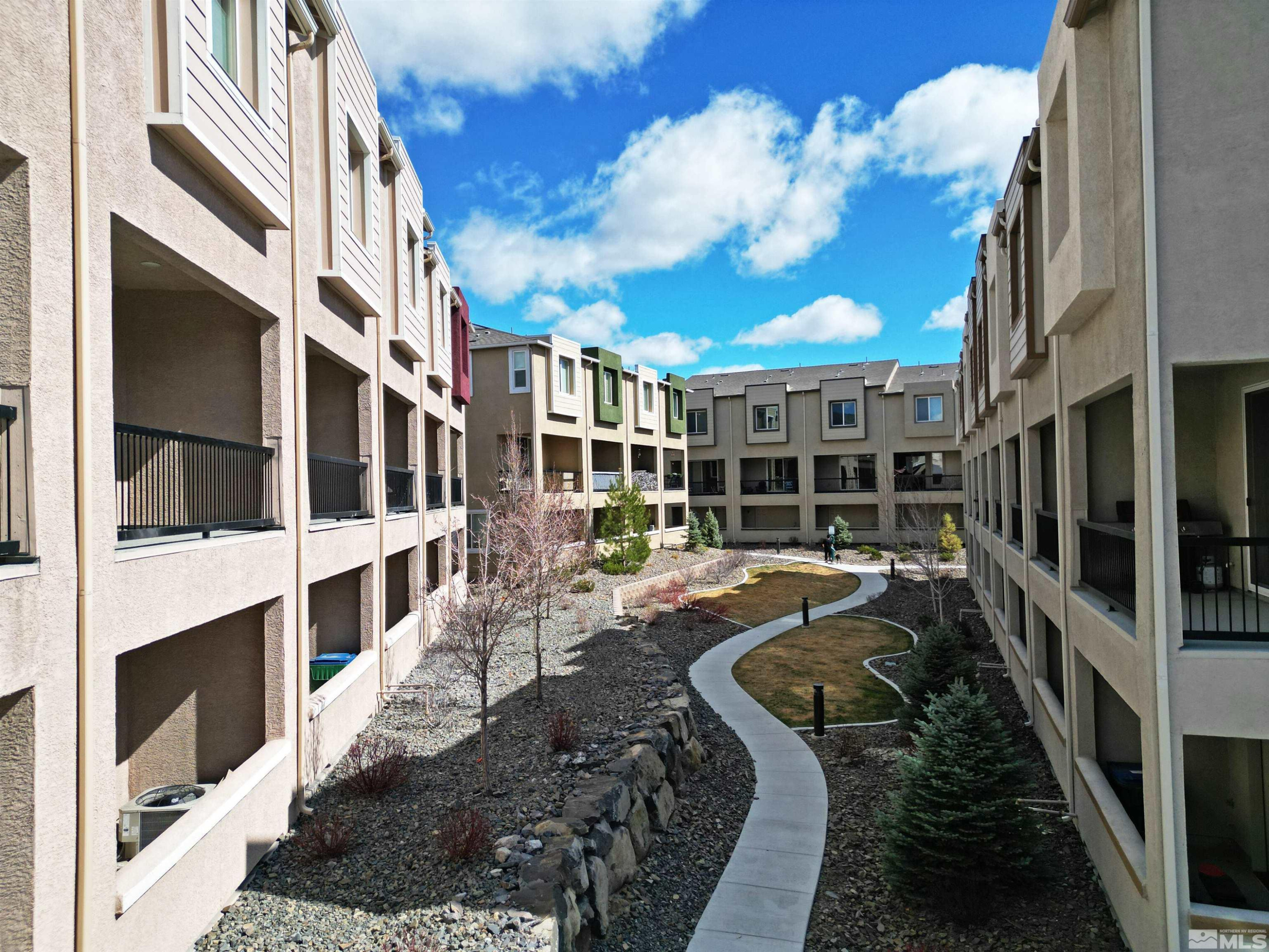 3006 Sterling Ridge Circle Sparks, NV 89431 - Photo 22 of 29 a view of a house with a large window stairs and a yard