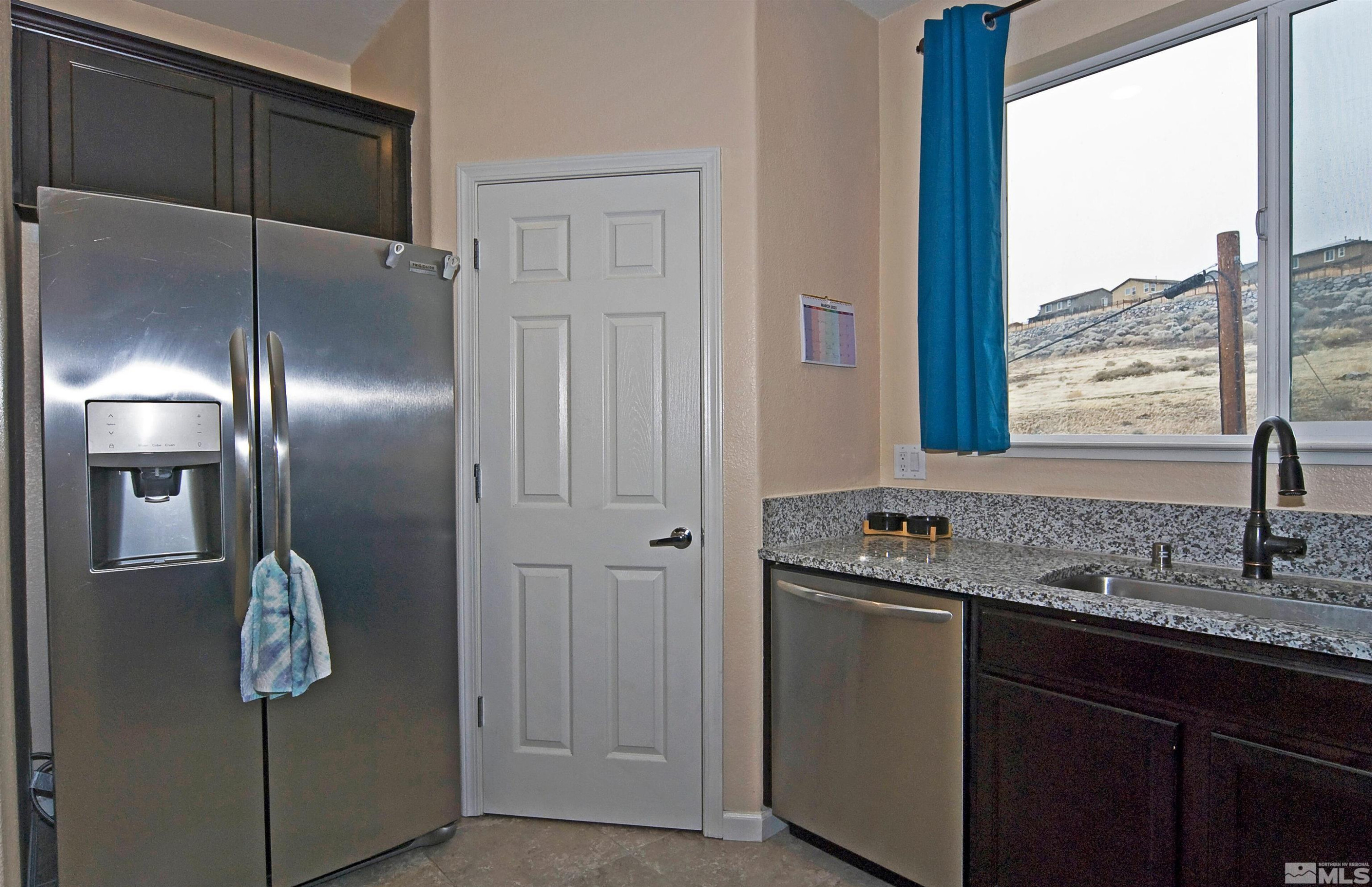3006 Sterling Ridge Circle Sparks, NV 89431 - Photo 4 of 29 a kitchen with stainless steel appliances granite countertop a refrigerator and a sink
