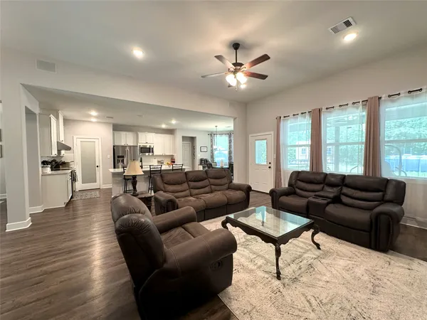 a large white kitchen with stainless steel appliances
