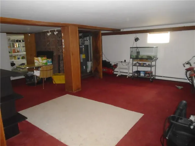 a living room with furniture a rug and gym equipment
