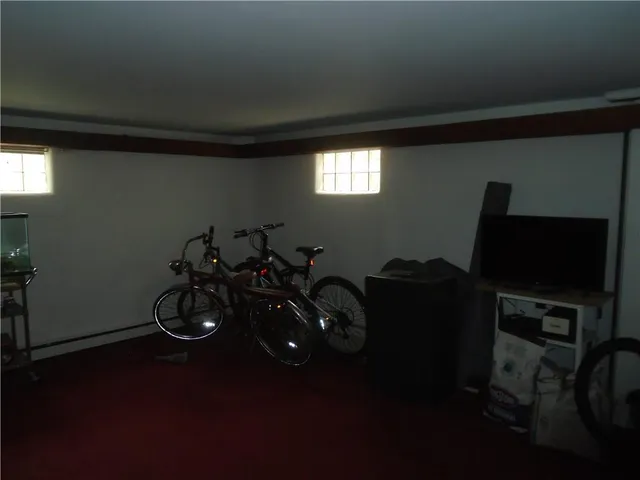 a living room with furniture and a fan