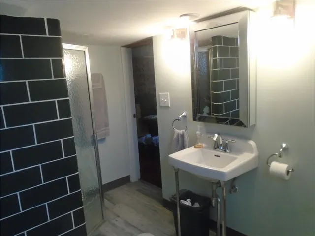 a bathroom with a sink toilet vanity and window
