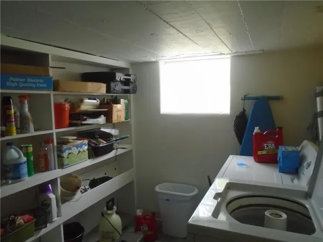 a room with a book shelf and a couch