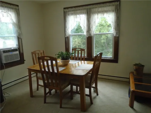 a dining room with furniture and window