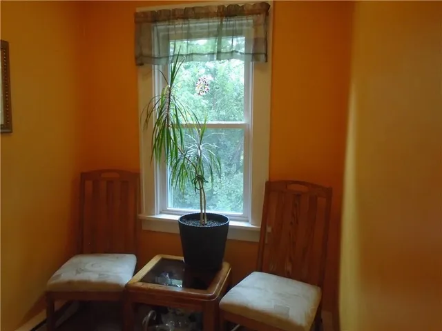 a view of a dining room with furniture and a window