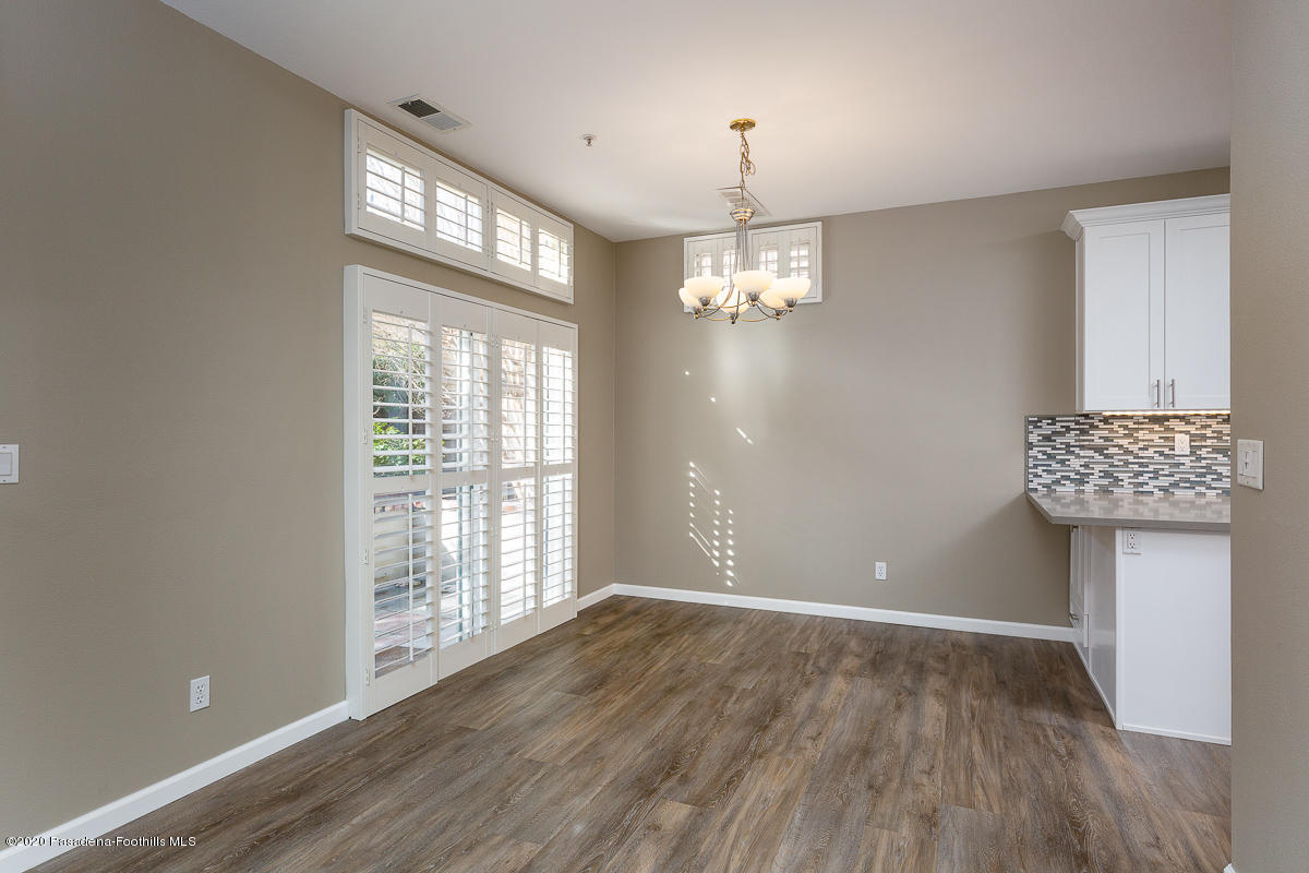 306 Alpine Street, Unit 3 Pasadena, CA 91106 - Photo 11 of 26 a view of an empty room with a window and wooden floor