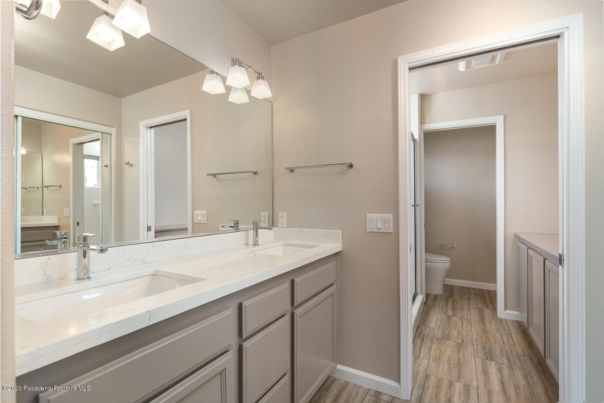 306 Alpine Street, Unit 3 Pasadena, CA 91106 - Photo 17 of 26 a bathroom with a sink a toilet and a large mirror