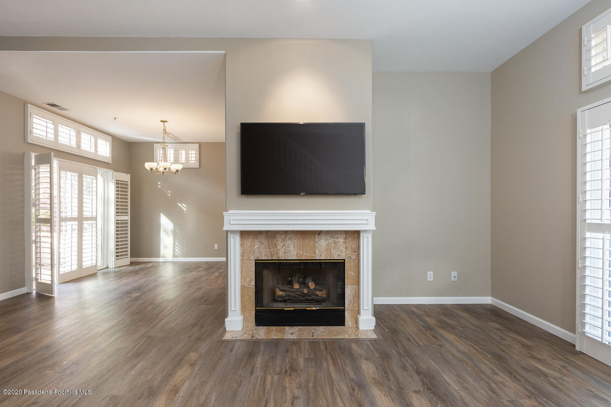 306 Alpine Street, Unit 3 Pasadena, CA 91106 - Photo 3 of 26 a living room with a fireplace and a flat screen tv