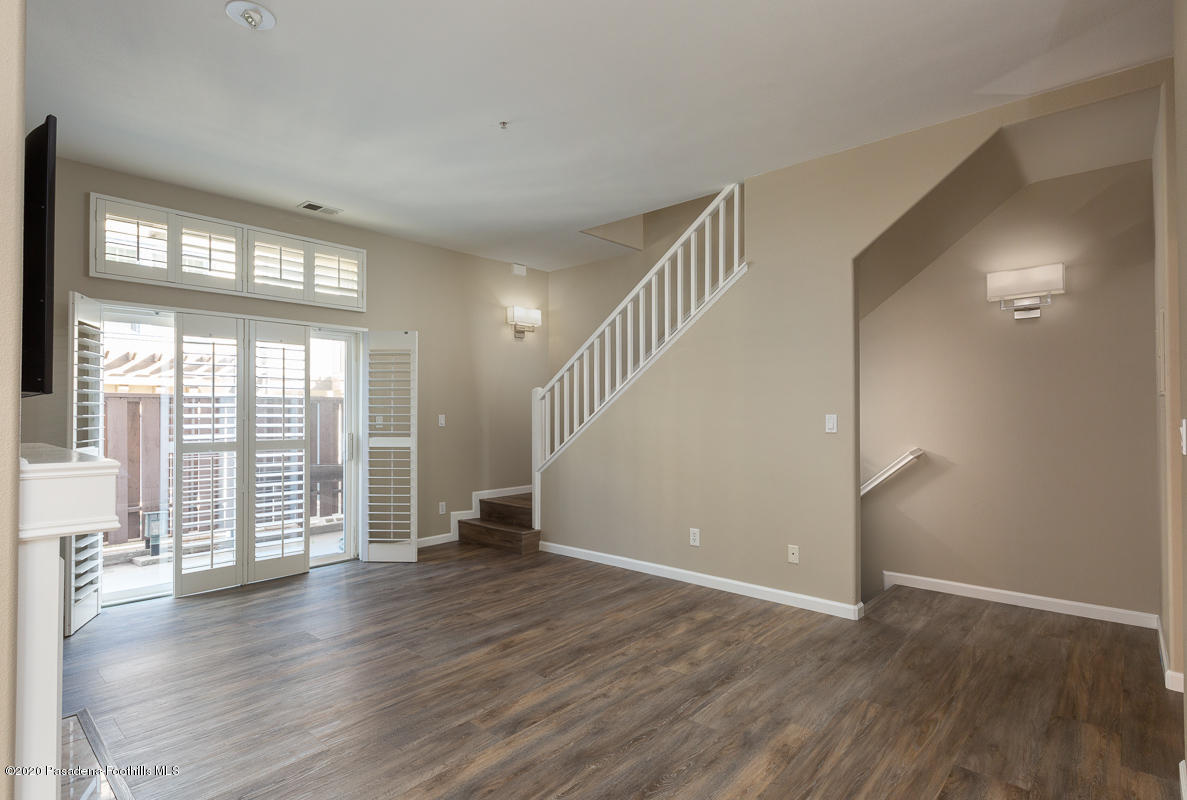 306 Alpine Street, Unit 3 Pasadena, CA 91106 - Photo 5 of 26 a view of an empty room with wooden floor and a window