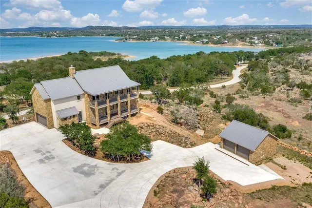 an aerial view of a house with a lake view