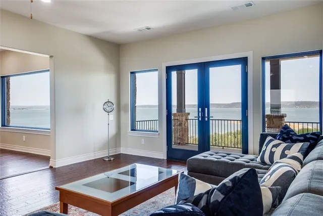 a living room with furniture and a floor to ceiling window