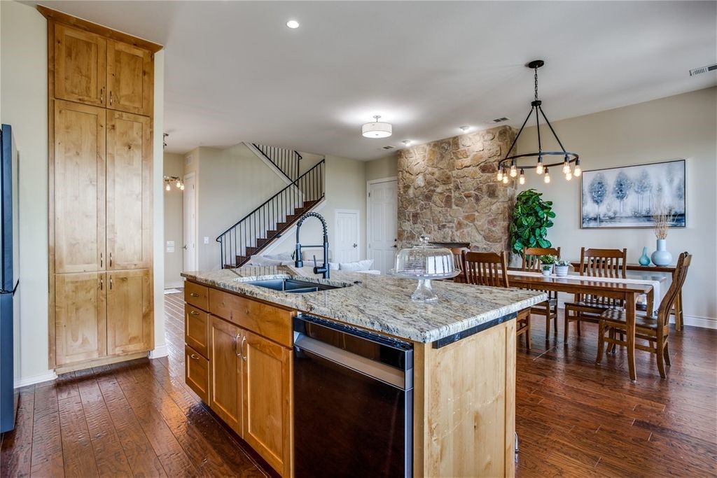 214 Peninsula Drive Burnet, TX 78611 - Photo 20 of 44 a kitchen with stainless steel appliances granite countertop a kitchen island a stove and a wooden floors