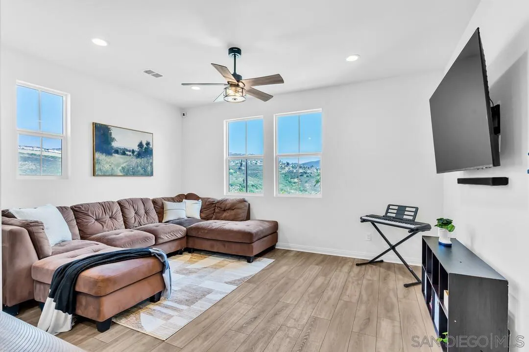 2811 Safflower Street Spring Valley, CA 91977 - Photo 10 of 28 a living room with furniture and a flat screen tv