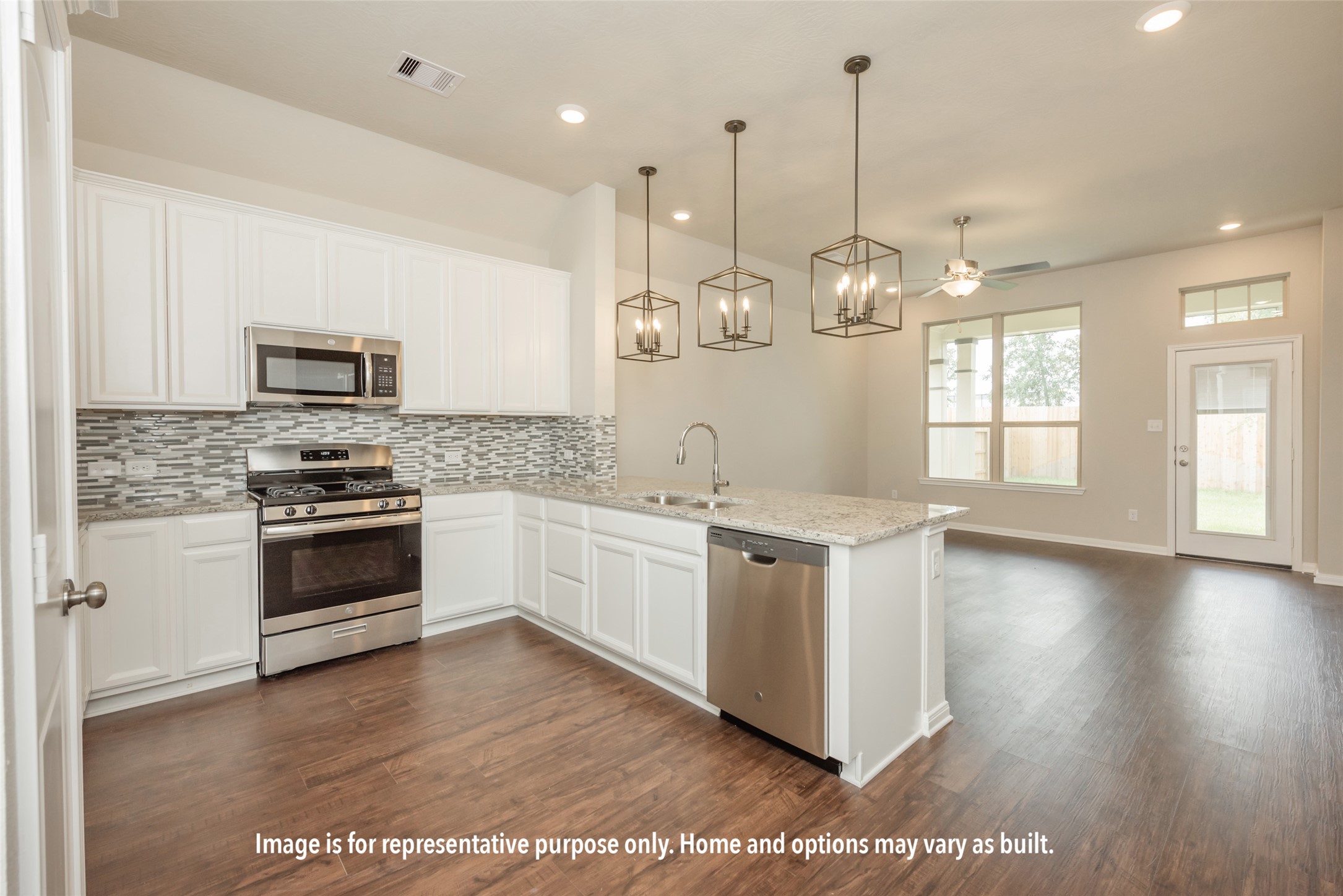 249 Lazy Lizzy Road Jarrell, TX 76537 - Photo 6 of 14 Rich wood-look flooring anchors a modern cooking area opening directly to a sunlit dining space.