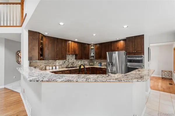 a large kitchen with stainless steel appliances kitchen island a large counter top and a sink