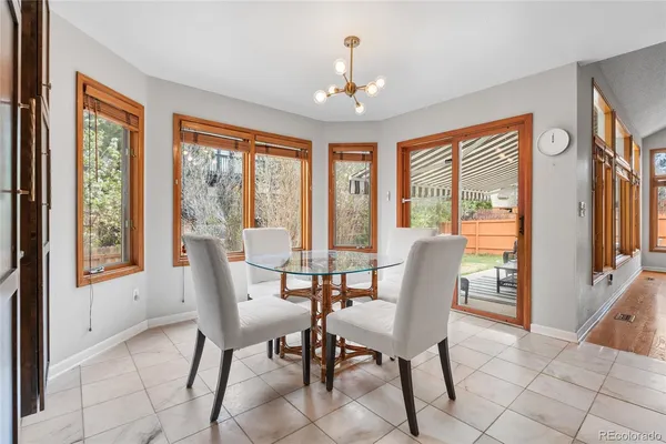 a view of a dining room with furniture large windows and wooden floor