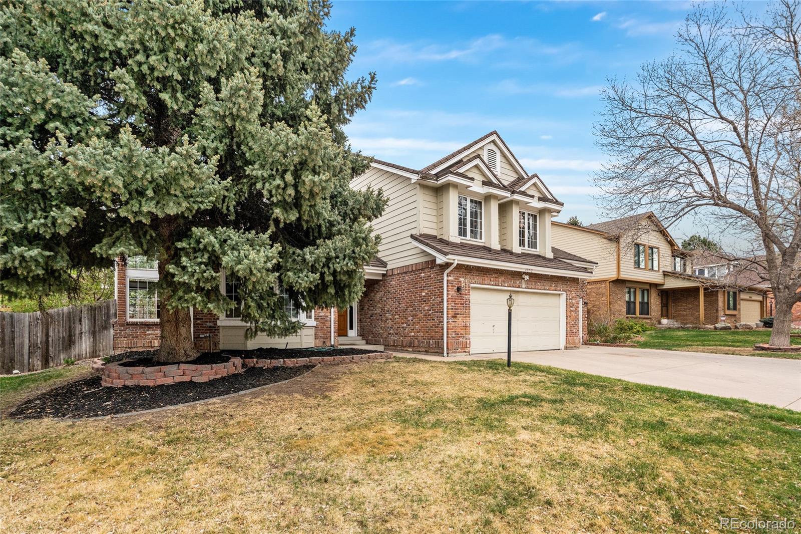 4852 South Carson Street Aurora, CO 80015 - Photo 2 of 50 a front view of a house with a yard