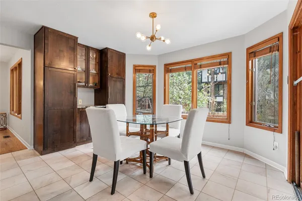 a view of a dining room with furniture large window and refrigerator