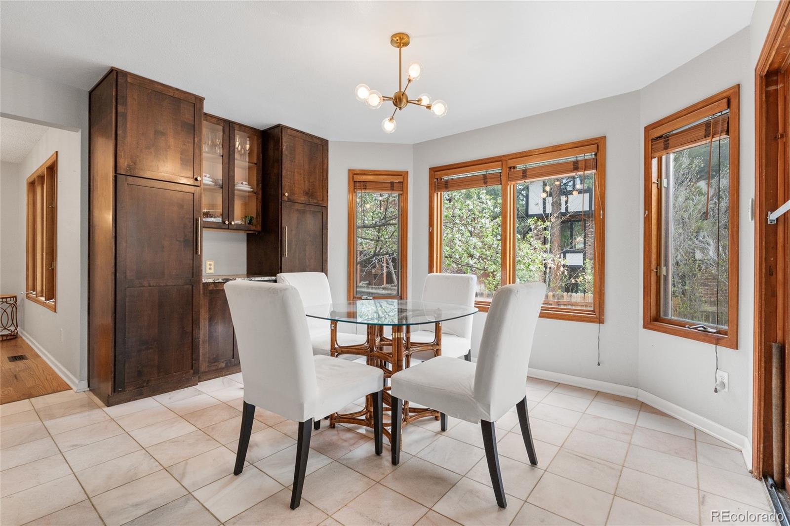 4852 South Carson Street Aurora, CO 80015 - Photo 21 of 50 a view of a dining room with furniture large window and refrigerator