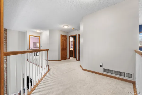 a bedroom with a bed and a flat tv screen on dresser