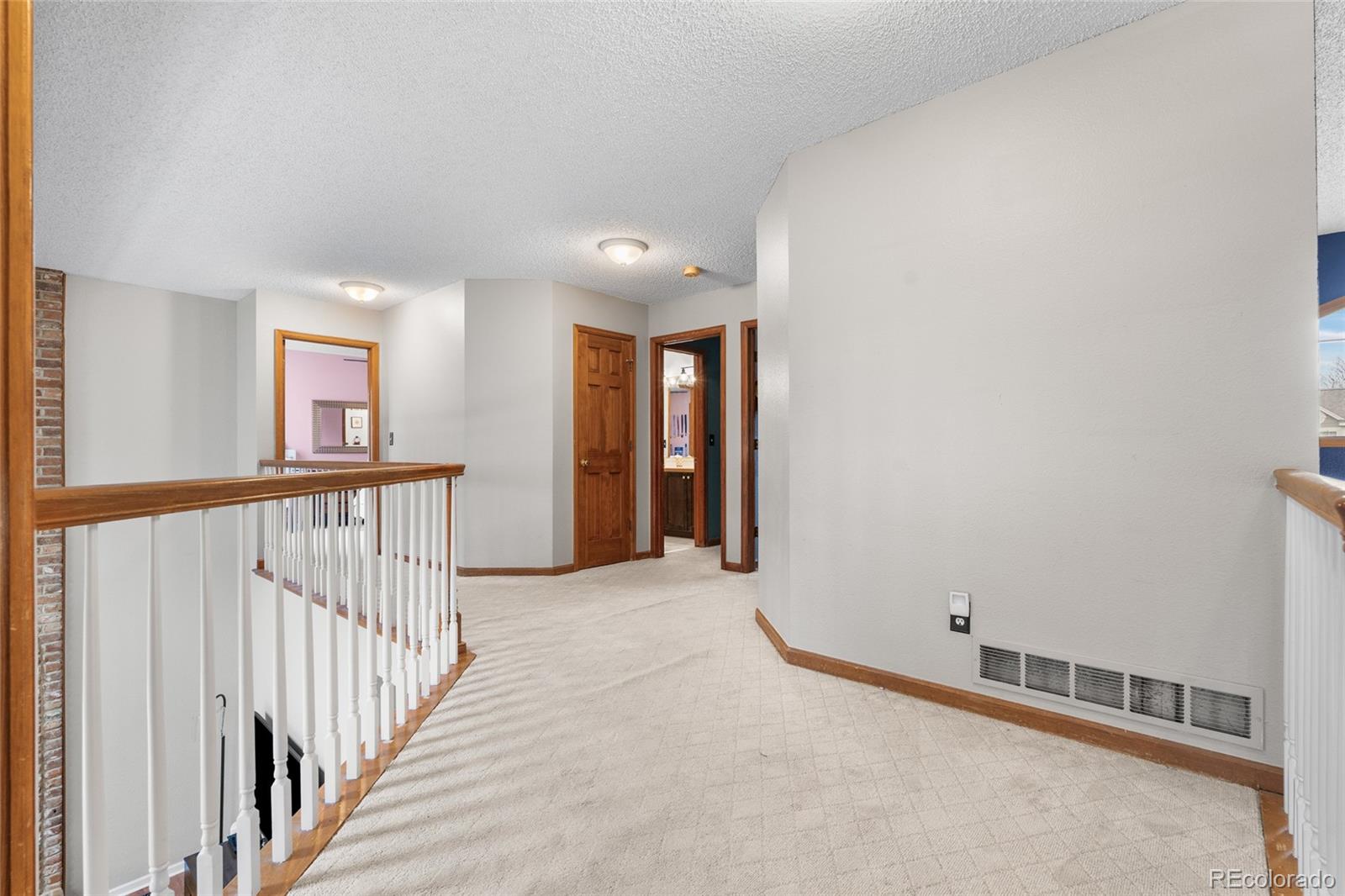 4852 South Carson Street Aurora, CO 80015 - Photo 31 of 50 a view of a hallway with windows