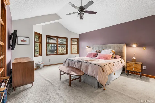 a bed room with a bed and a flat tv screen