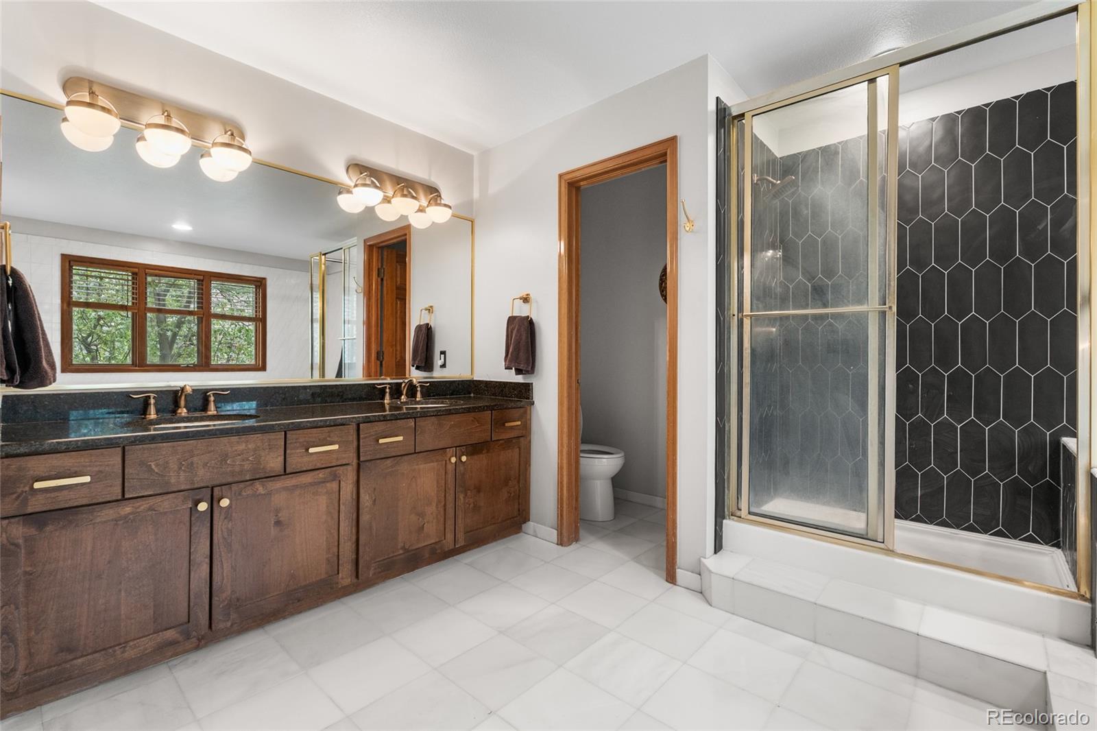 4852 South Carson Street Aurora, CO 80015 - Photo 35 of 50 a bathroom with a granite countertop sink mirror and double