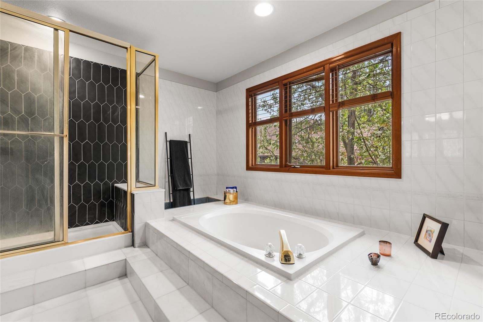4852 South Carson Street Aurora, CO 80015 - Photo 36 of 50 a white bath tub sitting next to a window