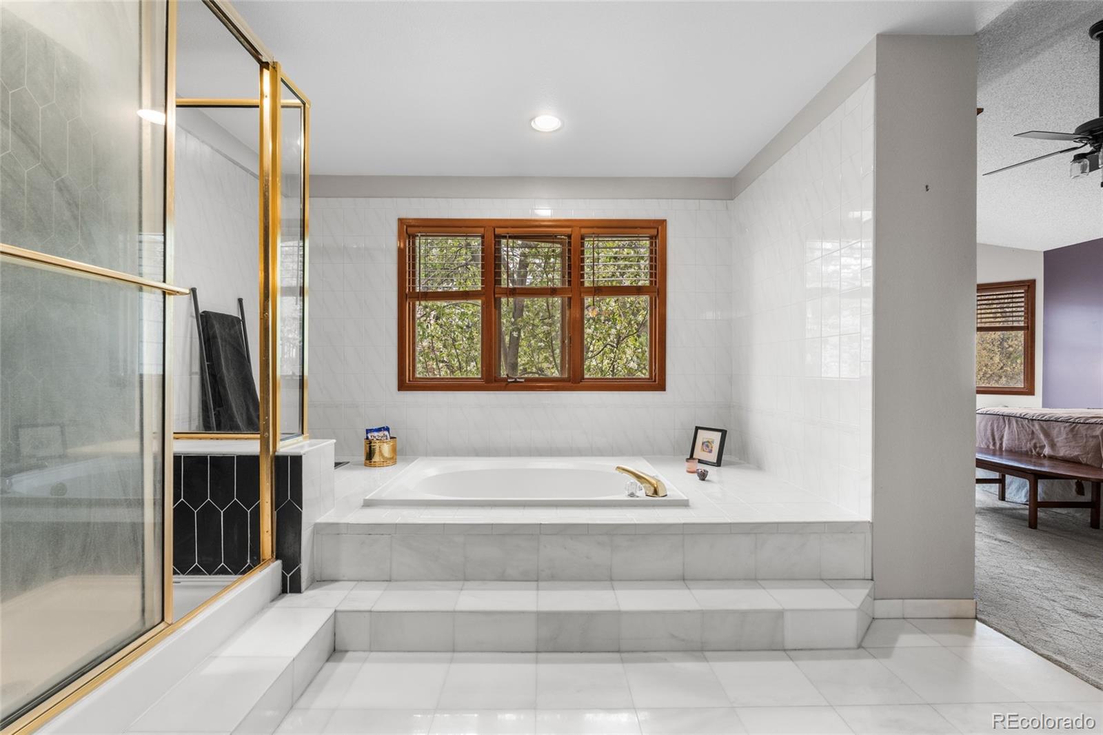 4852 South Carson Street Aurora, CO 80015 - Photo 37 of 50 a bathroom with a bathtub and a shower