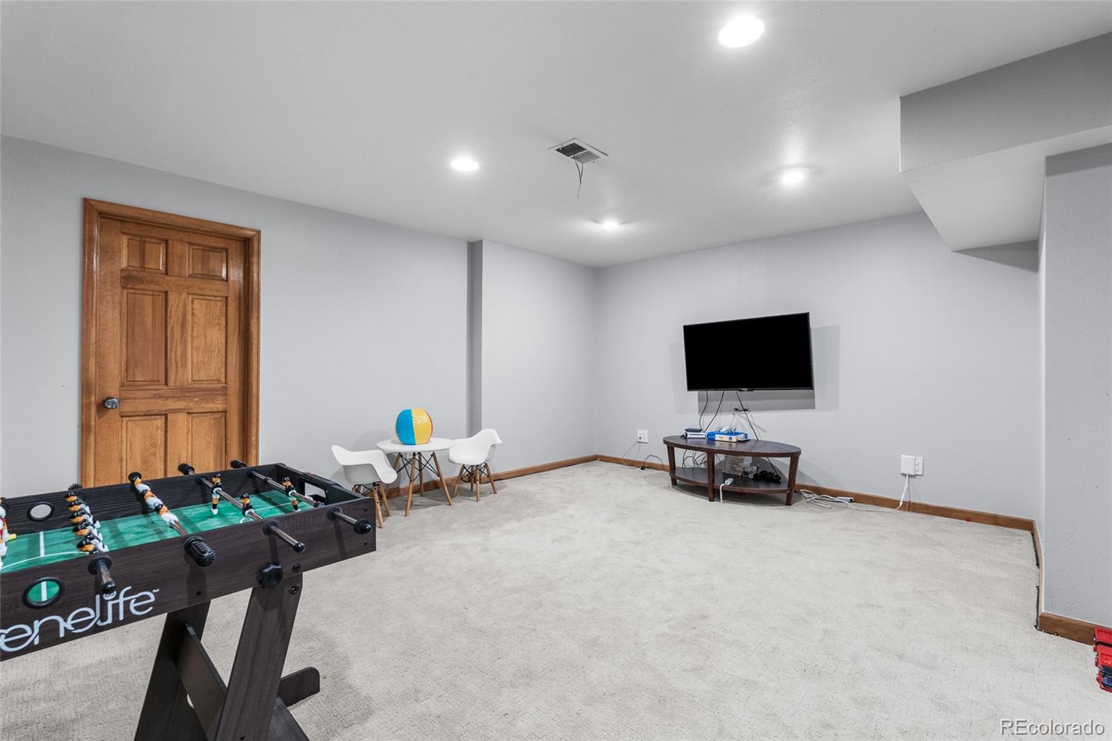 4852 South Carson Street Aurora, CO 80015 - Photo 45 of 50 a living room with furniture and a flat screen tv