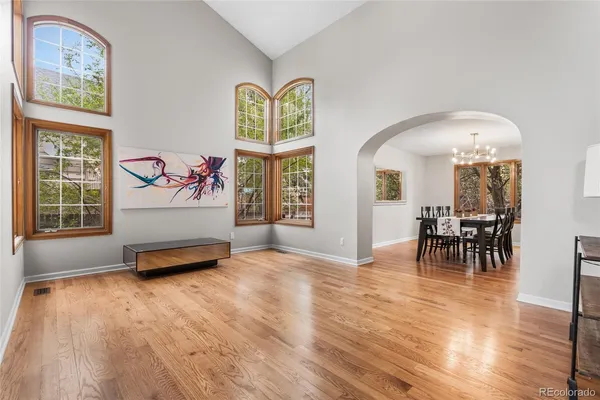 a living room with furniture and a table with wooden floor